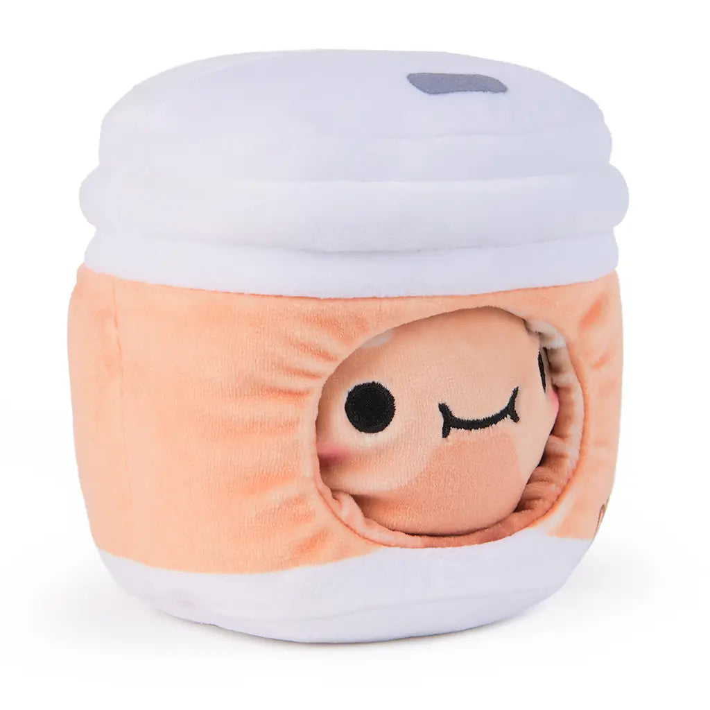 Side angle of a reversible plush toy featuring a dumpling face peeking through a soft orange and white tea cup with “Cheeky” embroidered and illustrated drink icons.