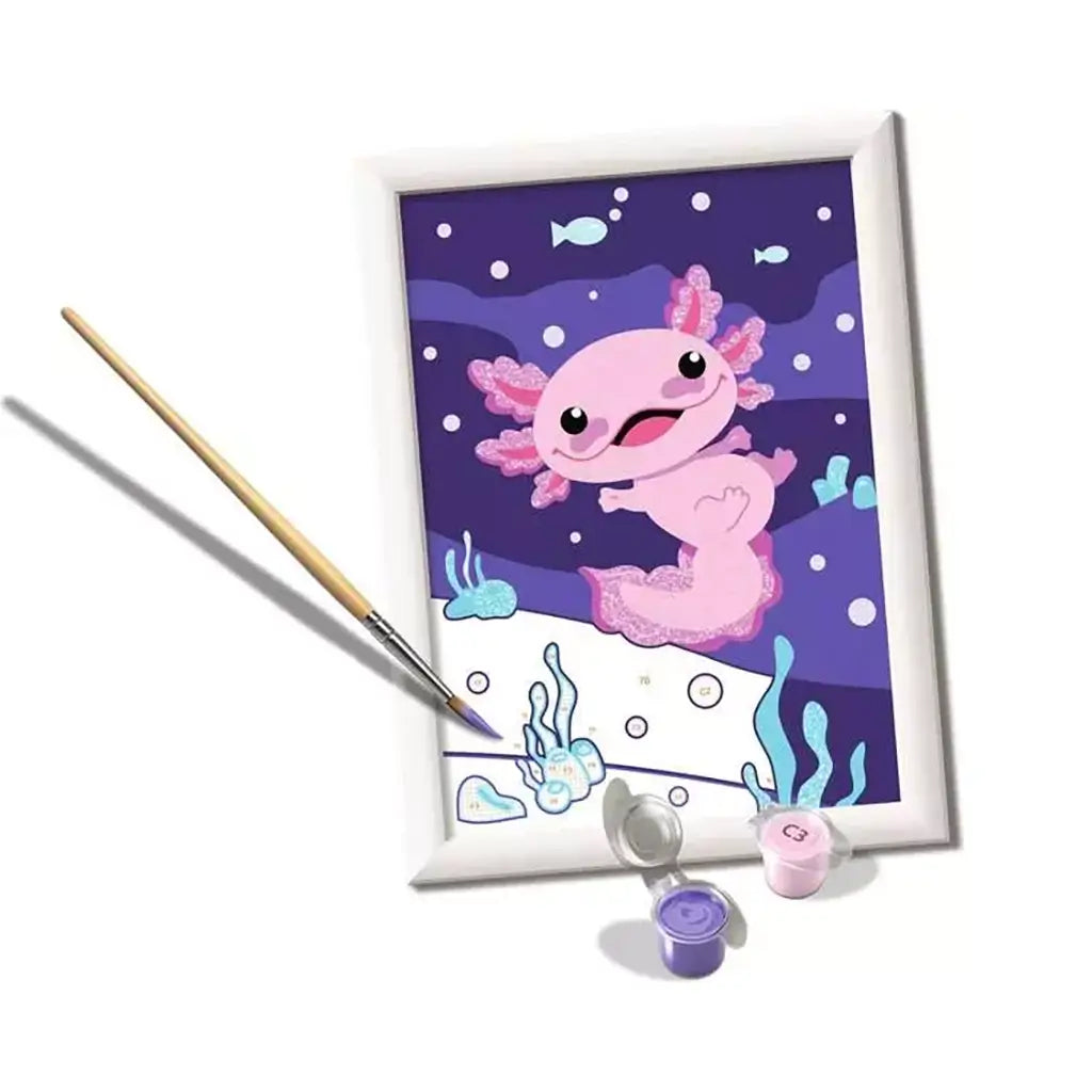 In-progress CreArt painting of a cheerful axolotl swimming underwater, with numbered paint areas, brush, and pastel paint pots in view.