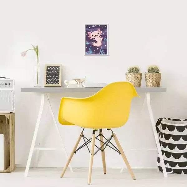 Finished CreArt axolotl painting framed and displayed above a desk with a yellow chair, adding playful underwater charm to a child's room decor.