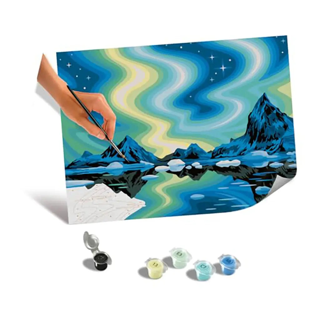 CreArt painting by numbers kit with northern lights canvas partially painted by hand, alongside paint pots in coordinated shades for completing the artwork.