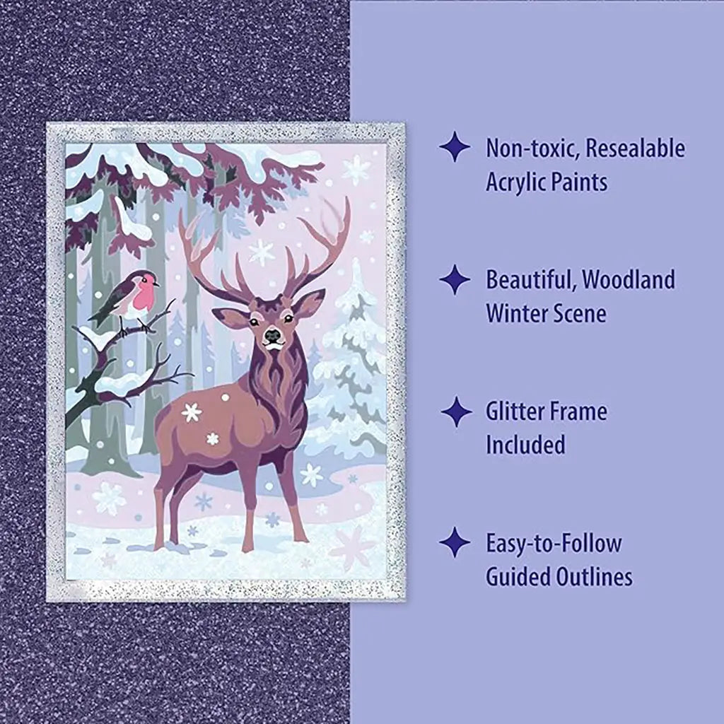 Close-up of Ravensburger CreArt festive friends kit artwork showing deer and bird in snowy forest, highlighted with glitter frame, resealable paints, and clear guided outlines.