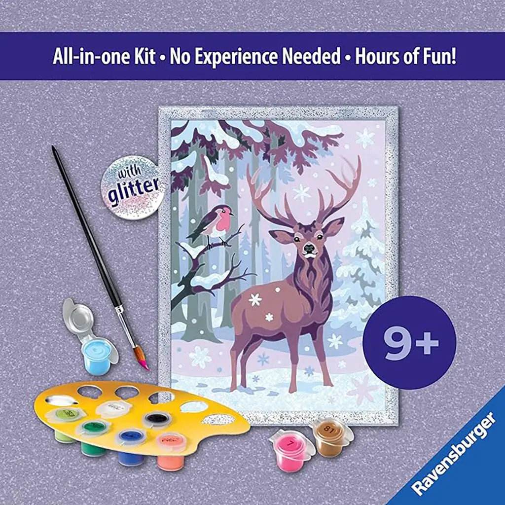 Back of Ravensburger CreArt festive friends paint by numbers kit box showing contents, paint palette, glitter frame, and woodland deer winter painting with included tools.