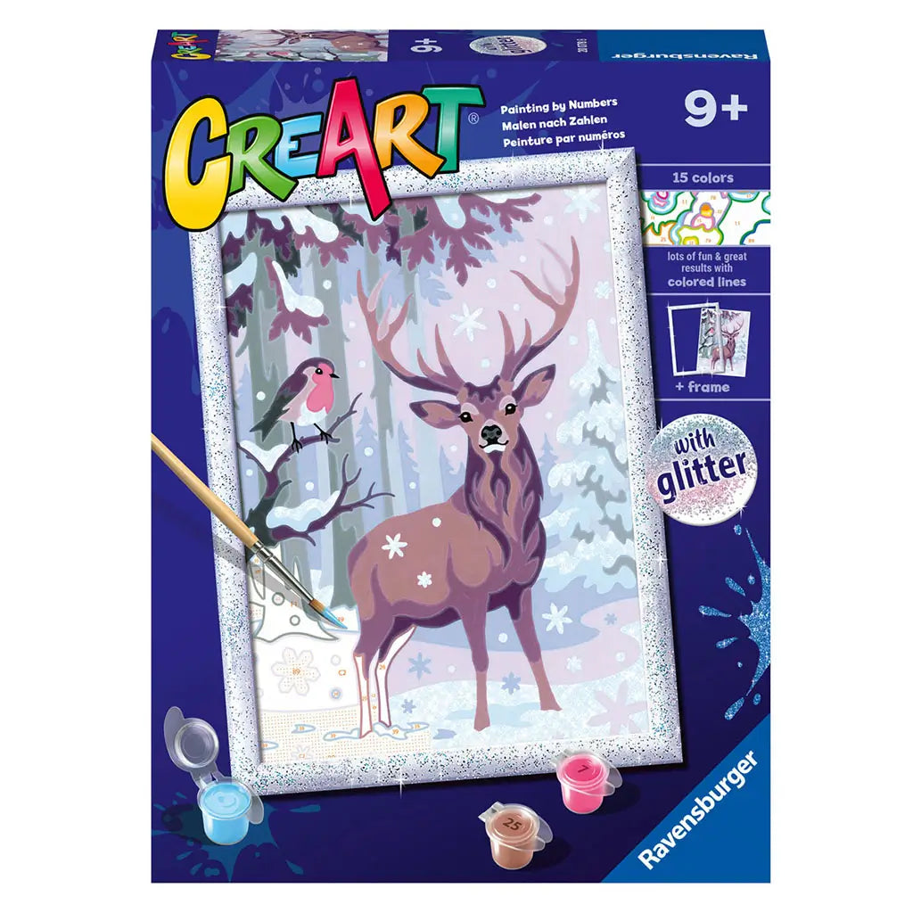 Front packaging of Ravensburger CreArt festive friends glitter painting kit, showing woodland deer and bird winter scene with glitter frame, recommended for ages 9 and older.