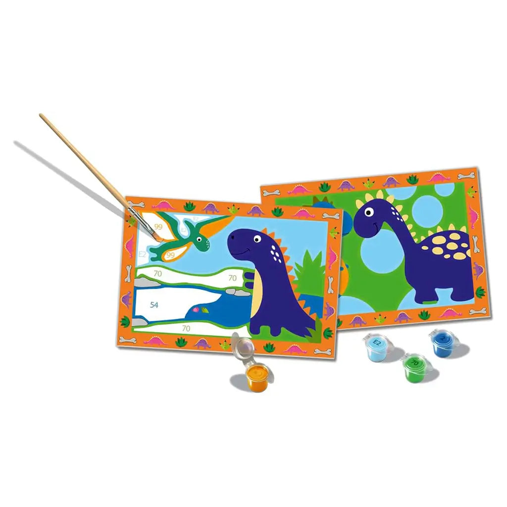 Dinosaur painting by numbers kit includes two framed designs with friendly dinosaurs, paintbrush, and paint pots for kids, showing bright green, blue, orange, and purple colors.