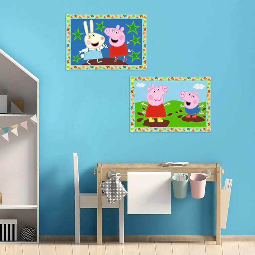 Peppa Pig CreArt Jr paintings displayed on blue wall above desk in children’s room, showing completed colorful artwork with Peppa and friends.