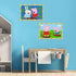 Peppa Pig CreArt Jr paintings displayed on blue wall above desk in children’s room, showing completed colorful artwork with Peppa and friends.