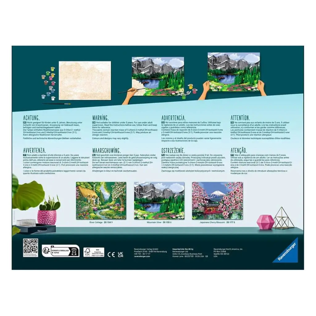 Back of Ravensburger CreArt package with painting instructions, warnings, and preview images of different paint by numbers designs including mountain view.