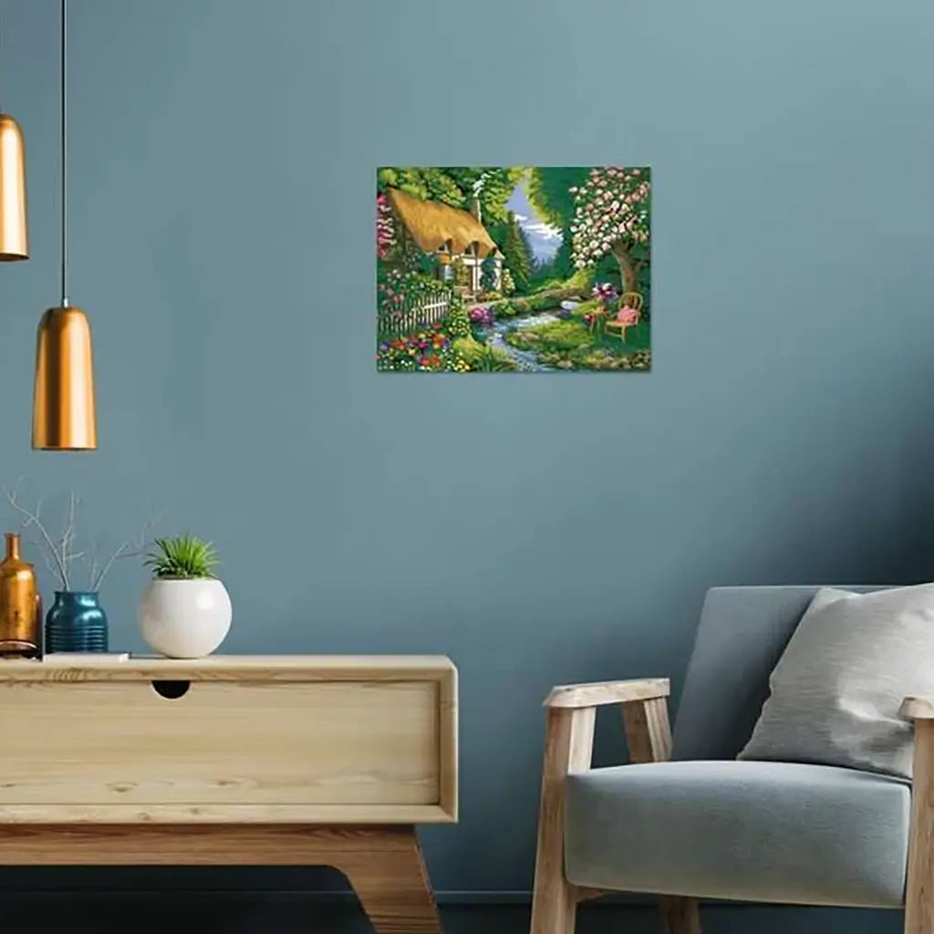 Completed River Cottage paint by numbers artwork framed on a blue living room wall above a modern wooden table with decor, highlighting its decorative home display use.