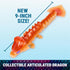 Articulated dragon toy in translucent orange plastic with faceted, scale-like segments, long jointed body, and fan-shaped tail, displayed on a blue background highlighting the new 9-inch collectible size.