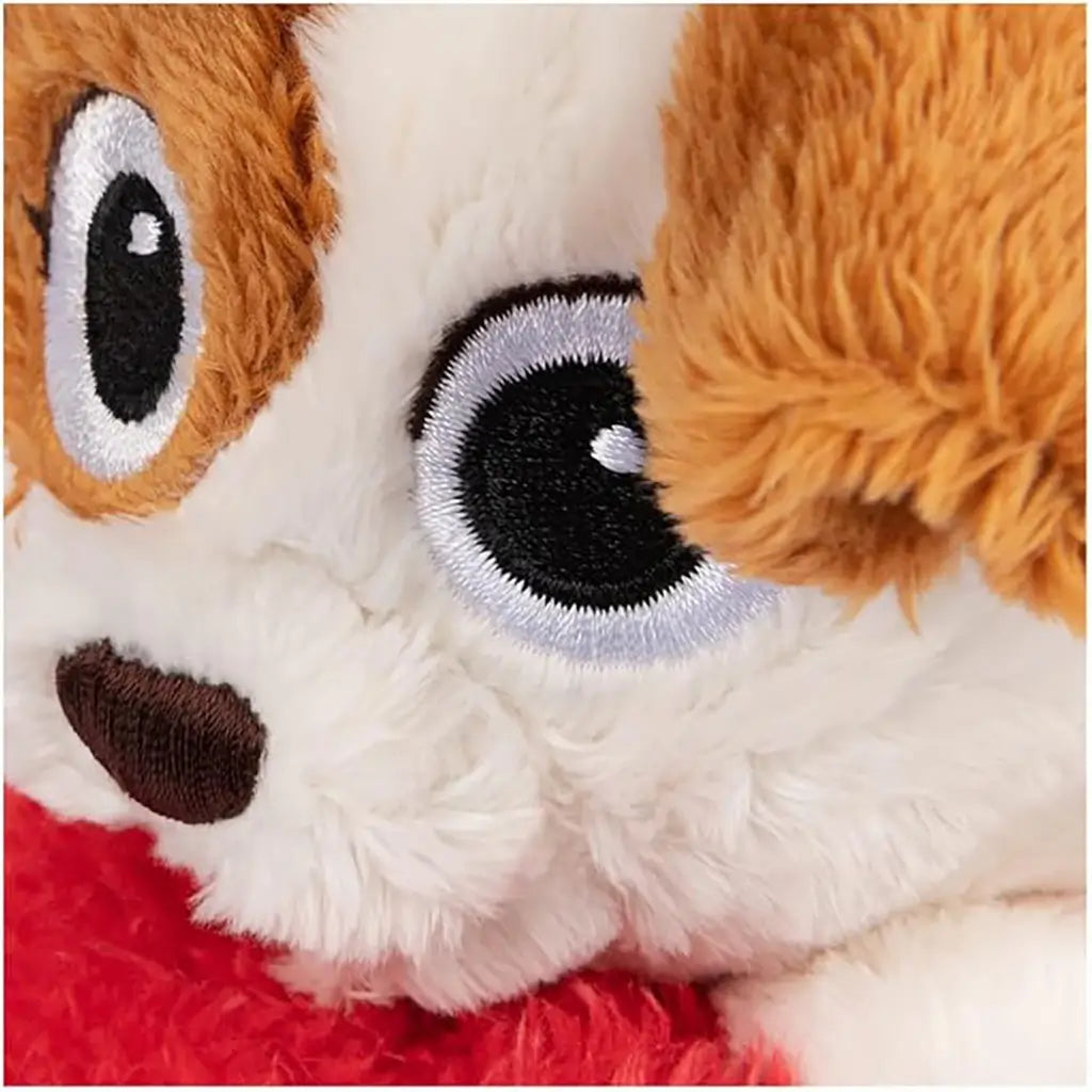 Close-up of plush puppy Tango’s embroidered black-and-white eyes and brown ear detail, highlighting soft fuzzy fabric texture and quality stitching for durable play.