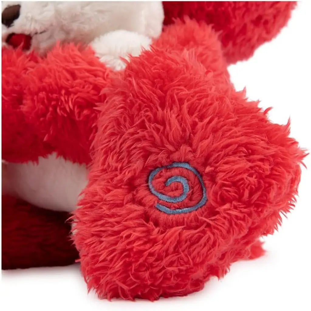 Close-up of plush Elmo’s fuzzy red foot with embroidered blue swirl design, showing fabric texture and stitched details for added character and durability.