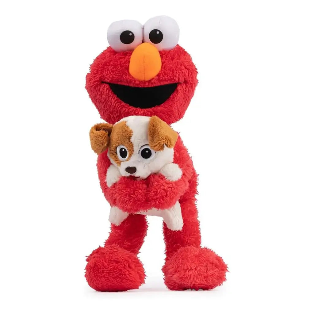 Red plush Elmo toy holding brown-and-white puppy Tango, both with embroidered eyes and soft texture, designed as 13-inch animated figure for interactive play and cuddling.
