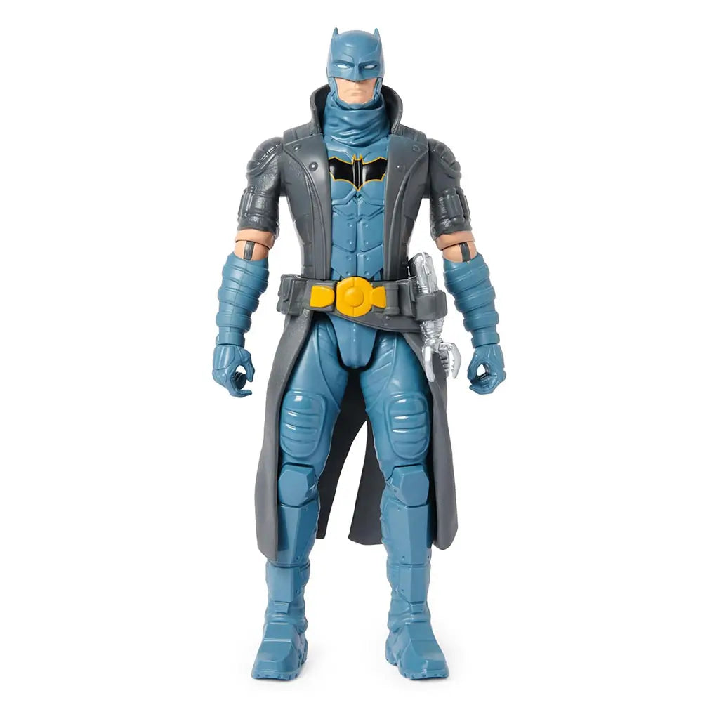 DC Comics Batman 12-inch action figure front view featuring gray coat, blue armor with chest emblem, yellow utility belt, and silver grapple accessory.