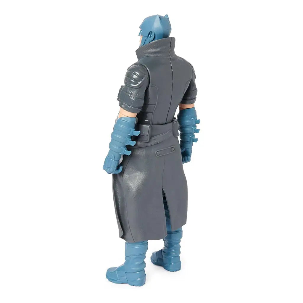 Rear angled view of DC Comics Batman 12-inch action figure, showing gray trench coat texture, sculpted blue boots, and armored gauntlets for added detail.