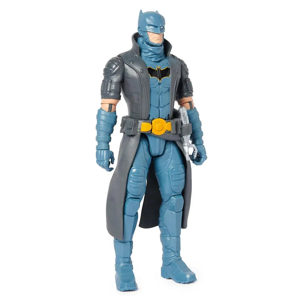 DC Comics Batman action figure wearing gray trench coat and blue armored outfit with yellow belt, standing upright with detailed sculpted textures.