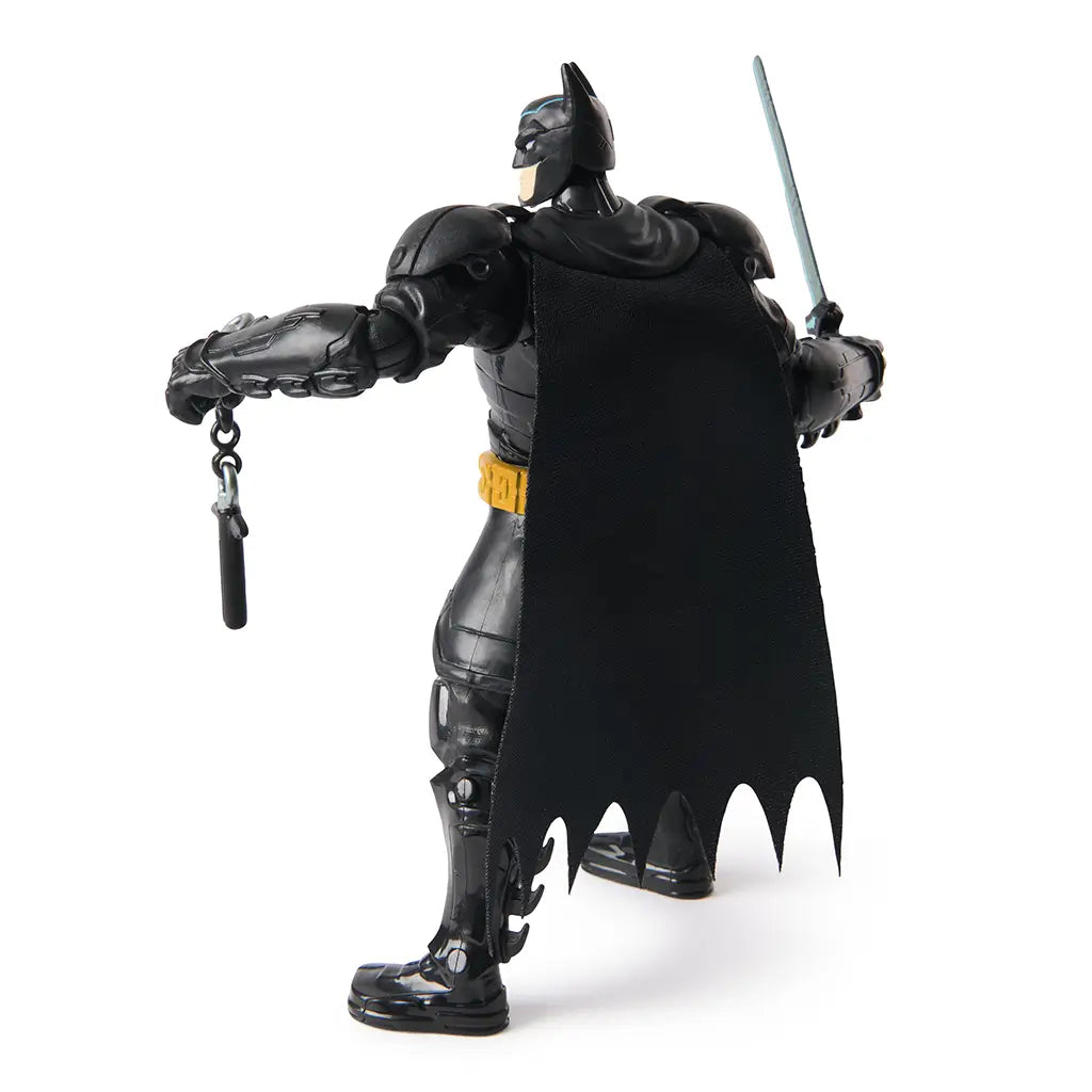 Rear view of Batman Ninja Strike action figure showing black cape and pink weapons in hand, highlighting the toy’s detailed sculpting and articulated limbs.