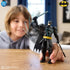 Young boy plays with Batman Ninja Strike action figure in dynamic pose, demonstrating swinging sword feature and engaging superhero-themed imaginative play.