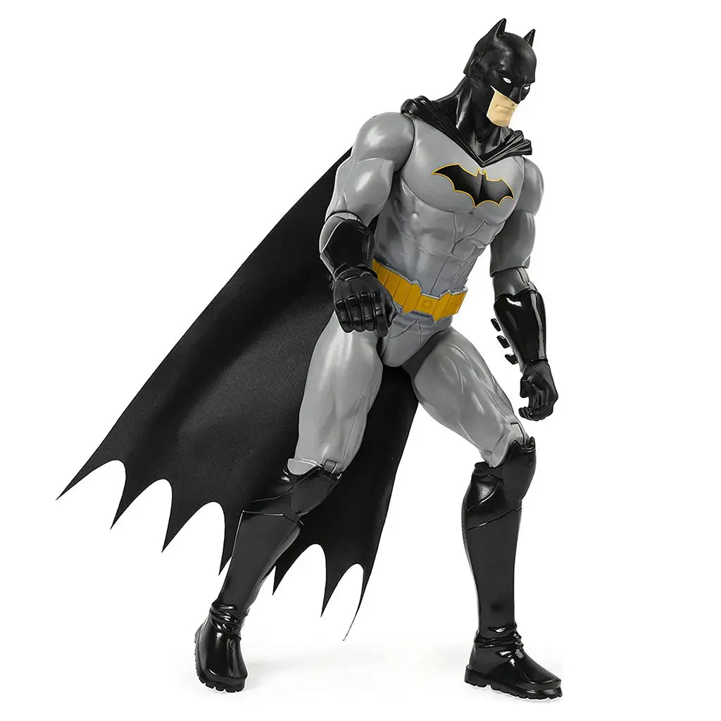DC Comics Batman 12-inch action figure in gray and black costume with yellow belt and flowing cape, displayed in a dynamic crouching pose to highlight articulation on white background.