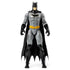 DC Comics Batman 12-inch action figure wearing gray bodysuit, black boots, gloves, and cape with yellow utility belt, shown standing upright in a front-facing pose against a plain background.