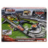 Disney Pixar Cars Piston Cup Action Speedway packaging showing the assembled dark gray track, booster, pit area, and Lightning McQueen car, with colorful graphics, product photos, and branding on the retail box front.