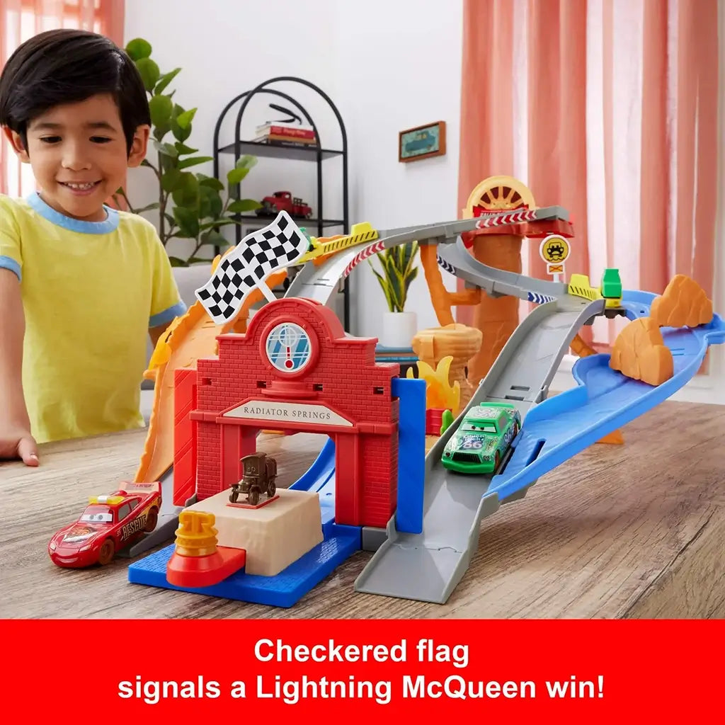 Disney Pixar Cars raceway playset featuring bright red plastic arch, smooth gray tracks, and a black-and-white checkered flag celebrating Lightning McQueen’s win on a Radiator Springs themed tabletop course.