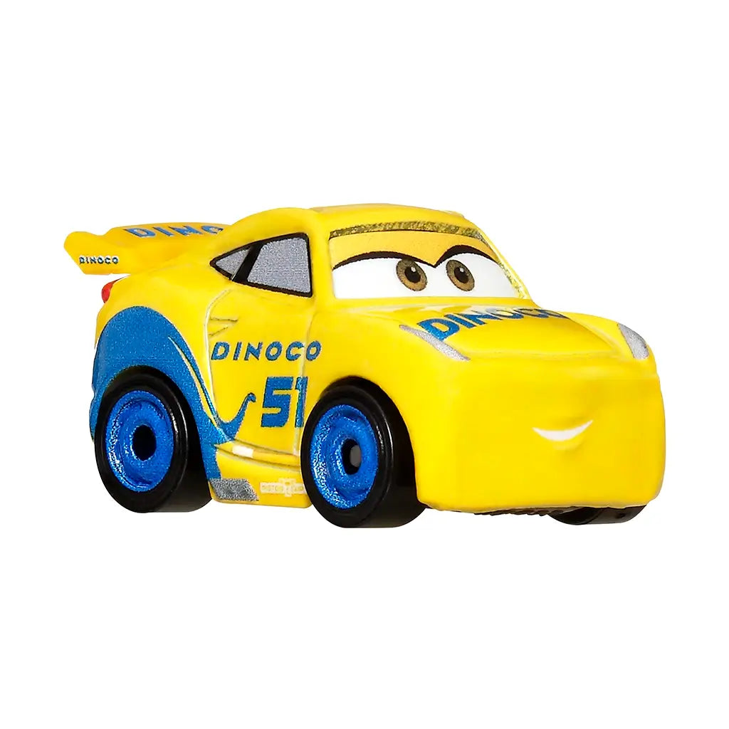 Left angled view of Dinoco Cruz Ramirez mini racer from Disney and Pixar Cars with bright yellow body, blue accents, and cheerful cartoon expression for interactive play.
