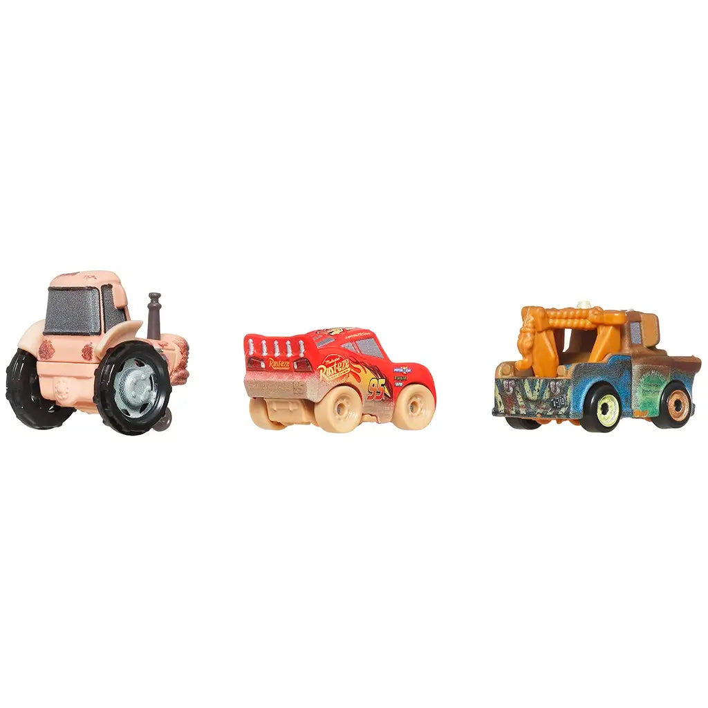 Rear angled view of three Disney and Pixar mini racers—Muddy Lightning McQueen, Tow Mater, and tractor—showing back details and colorful, mud-splattered paint.
