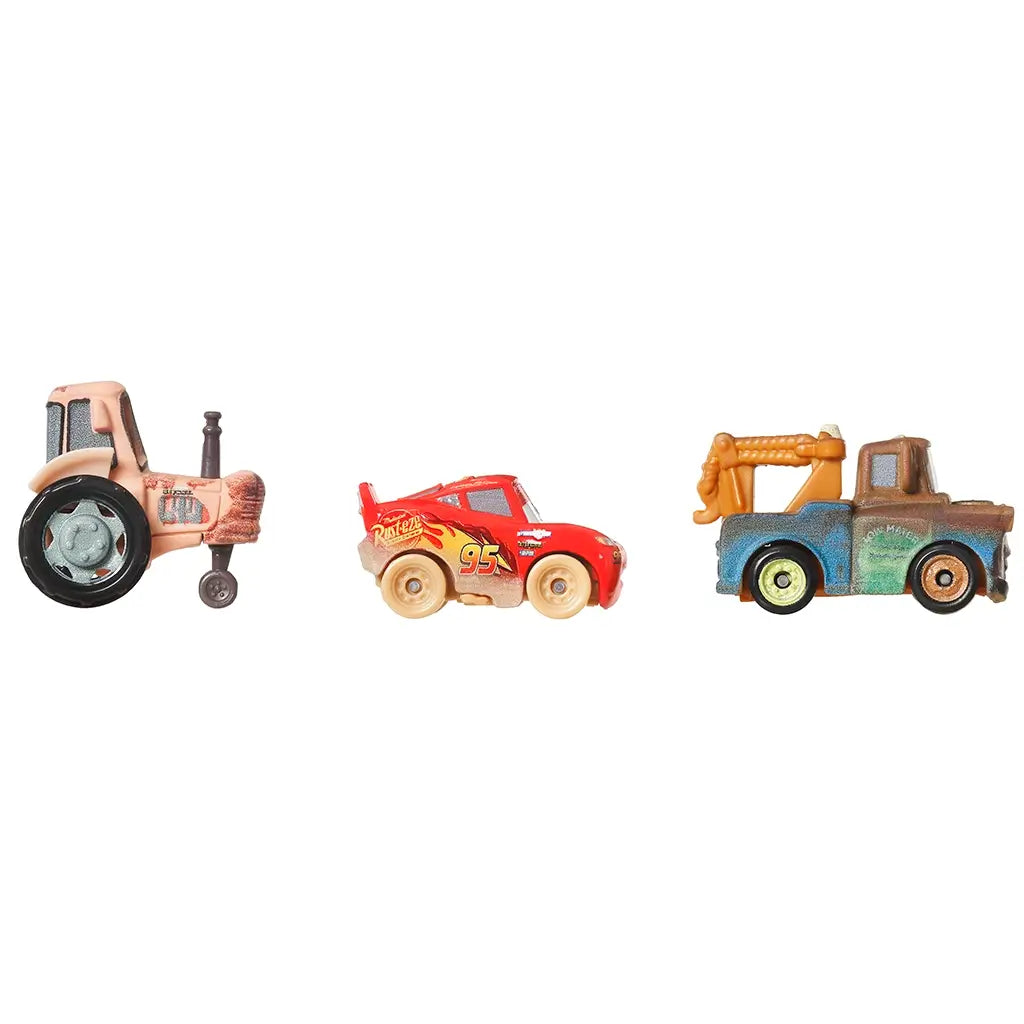 Side view of Disney and Pixar mini racers toy set with Muddy Lightning McQueen, Tow Mater, and a tractor, all with expressive faces and authentic muddy detailing.