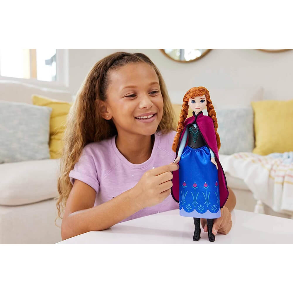 girl playing with Disney Frozen Anna Fashion Doll
