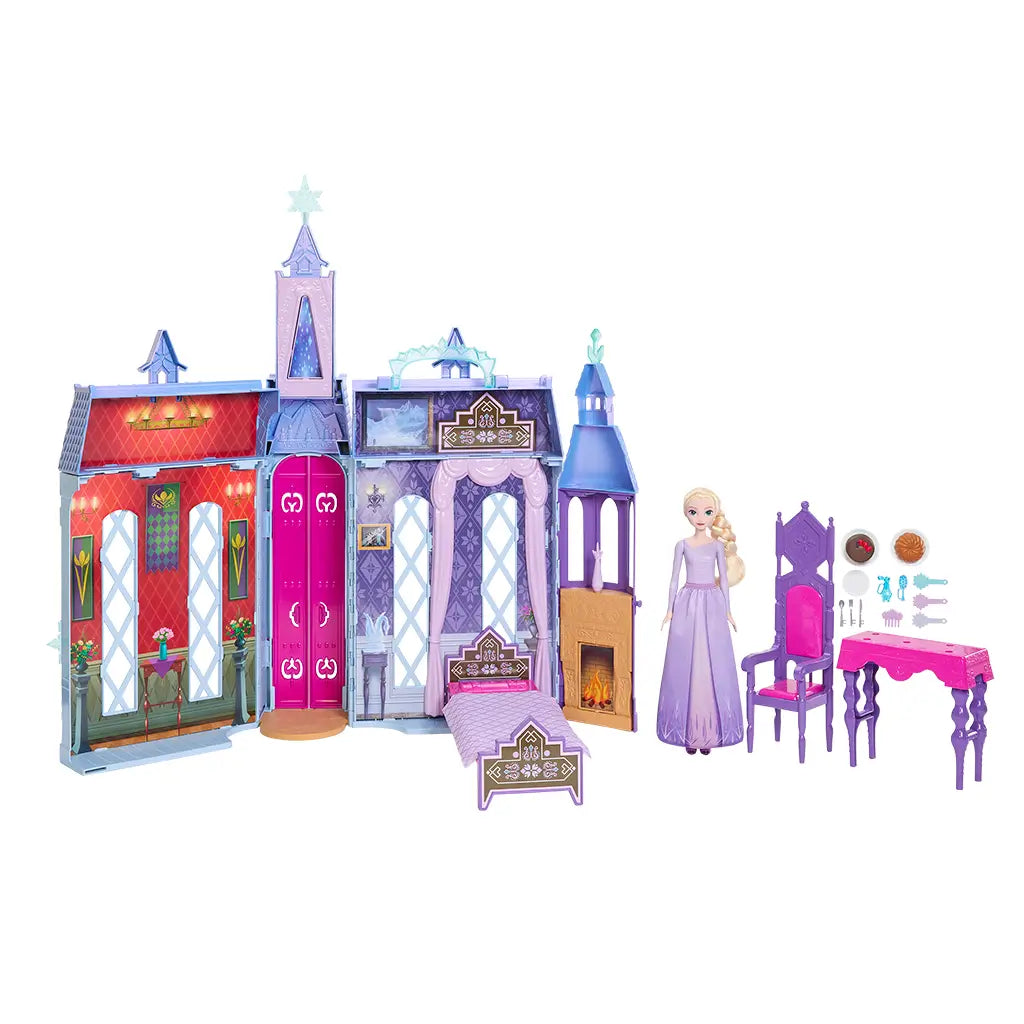 Disney Frozen Arendelle Castle playset with purple and pink castle walls, fold-out rooms, fireplace, bed, vanity, dining table, chairs, and an Elsa doll in lavender dress.
