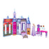 Disney Frozen Arendelle Castle playset with purple and pink castle walls, fold-out rooms, fireplace, bed, vanity, dining table, chairs, and an Elsa doll in lavender dress.
