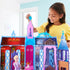 Smiling child in yellow shirt playing with Frozen Arendelle Castle playset, arranging Elsa doll, furniture, and transforming pieces inside the colorful fold-out castle.