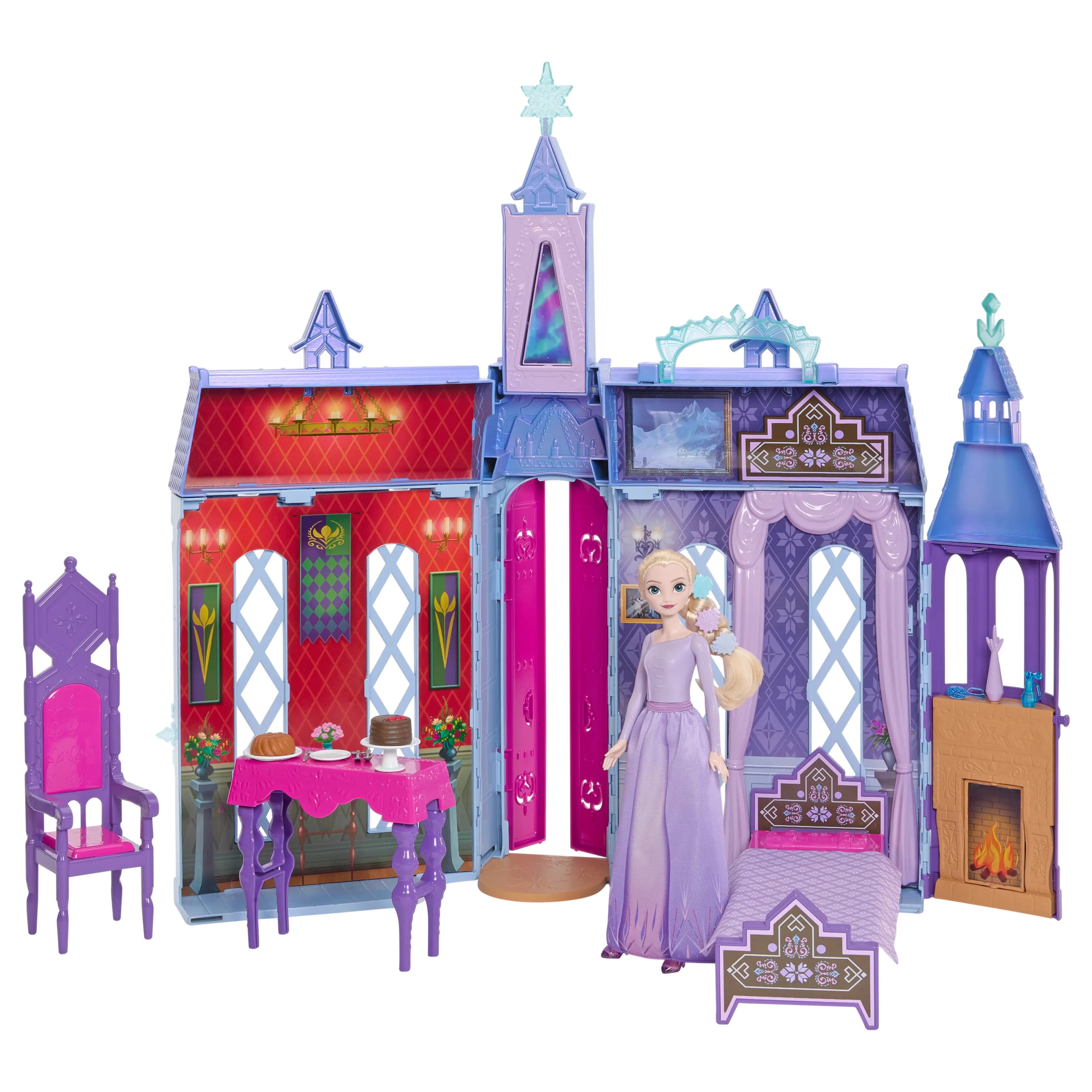 Disney Frozen Arendelle Castle playset opened with Elsa doll, purple and pink chairs, dining table with cakes, bed, and a glowing fireplace set inside castle walls.
