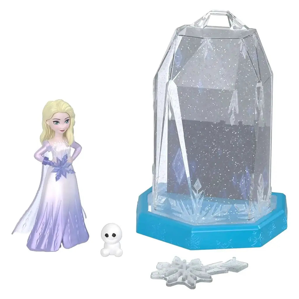 Disney Frozen Ice Reveal toy set featuring Elsa mini figure with a white snow creature, glittery snowflake accessories, and a translucent crystal container for magical unboxing fun.