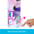 Close-up of hand opening a hidden compartment in the Disney Frozen Spin & Reveal Anna doll packaging, revealing a mystery accessory inside. Detailed toy description for collectors and children ages 3 and up.