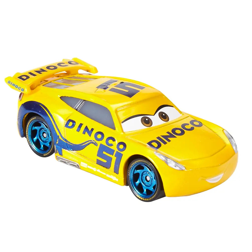 Disney Pixar Cars Dinoco Cruz Ramirez diecast shown at an angled view, featuring bright yellow glossy metal, aerodynamic racing body, blue Dinoco hood logo, number 51 graphics, metallic blue wheels, and confident character expression on white.