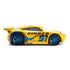 Disney Pixar Cars Dinoco Cruz Ramirez diecast left side view displaying bright yellow metal finish, smooth aerodynamic profile, flowing blue Dinoco wave graphics, large number 51, metallic blue wheels, and next-gen race car styling on white.