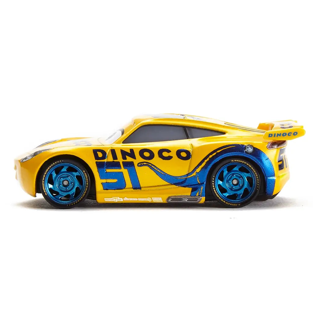Disney Pixar Cars Dinoco Cruz Ramirez diecast right side view with bright yellow glossy metal, bold blue Dinoco graphics, number 51 racing decals, metallic blue wheels, and low-profile next-gen race car silhouette on a clean white background.