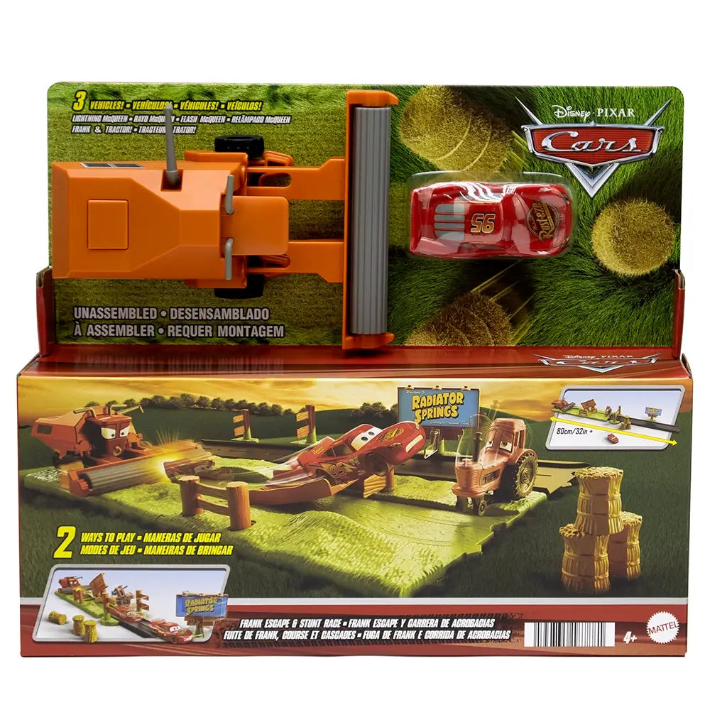 Disney Pixar Cars Frank Escape Stunt Race playset in retail box, including Lightning McQueen car, orange Frank combine harvester, track, tractor, and hay bales accessories.