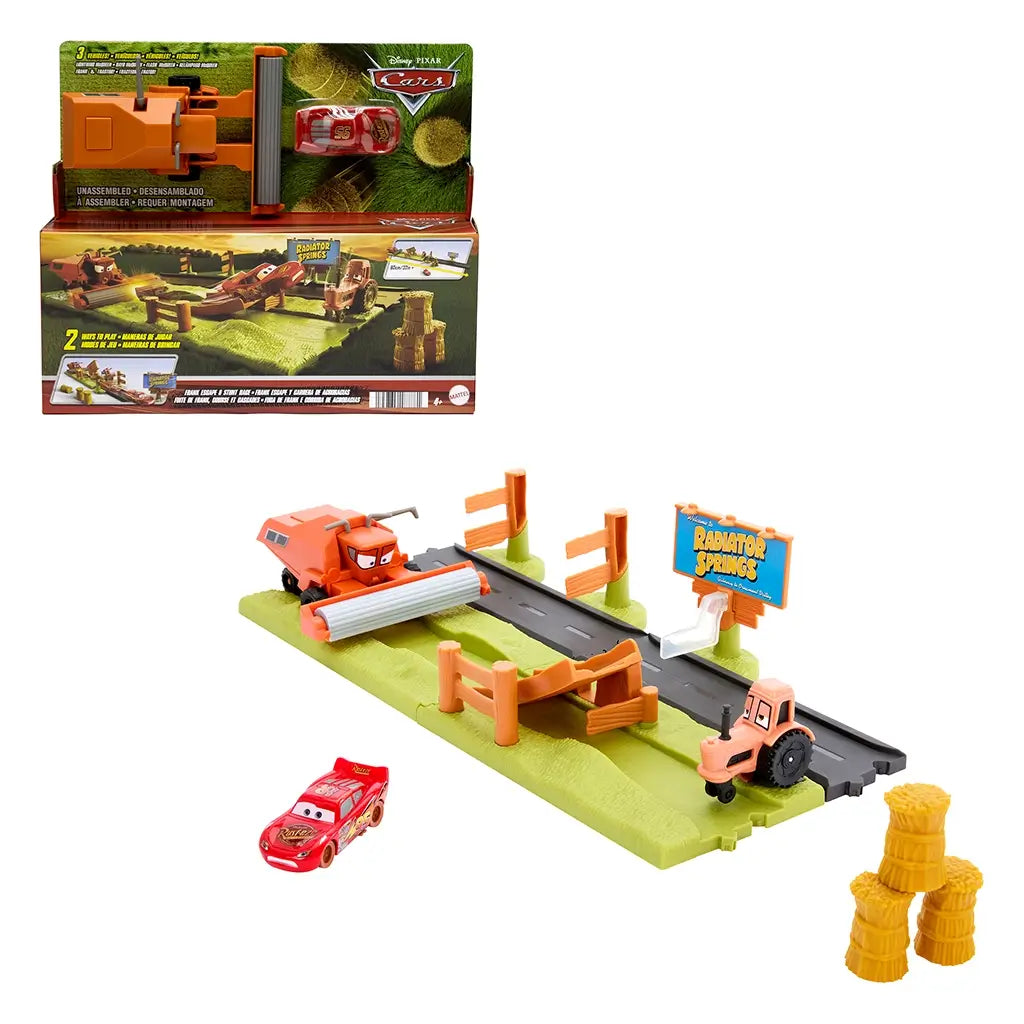 Disney Pixar Cars Frank Escape Stunt Race playset assembled, featuring Lightning McQueen car, ramp, orange Frank harvester, tractor, Radiator Springs sign, and hay bales.