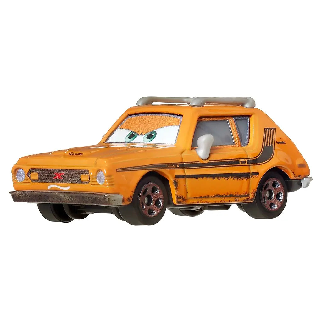 Disney Pixar Cars Grem diecast in bright orange with silver roof rack, black side detailing, rust effects, and expressive green eyes, positioned at a front angled view on white.