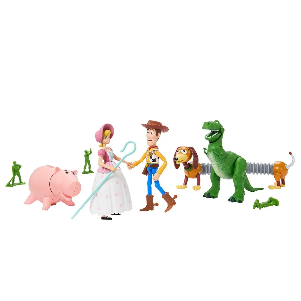 Toy Story Storytellers action figures including Woody, Bo Peep, Rex, Hamm, Slinky Dog, and army men posed together on a white background, highlighting their movable joints.