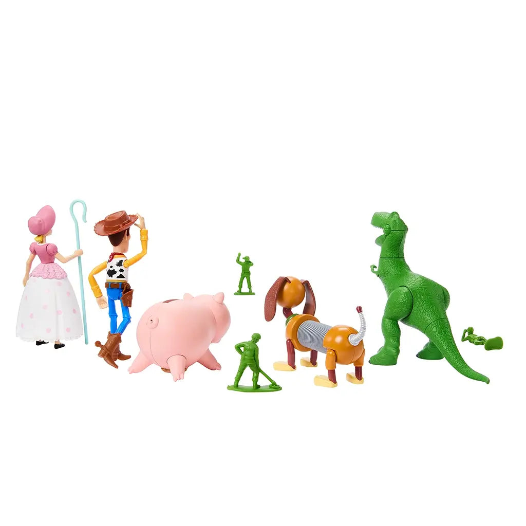 Rear angled view of Toy Story Storytellers figures showing back details of Woody, Bo Peep, Rex, Hamm, Slinky Dog, and green army men arranged against a plain background.