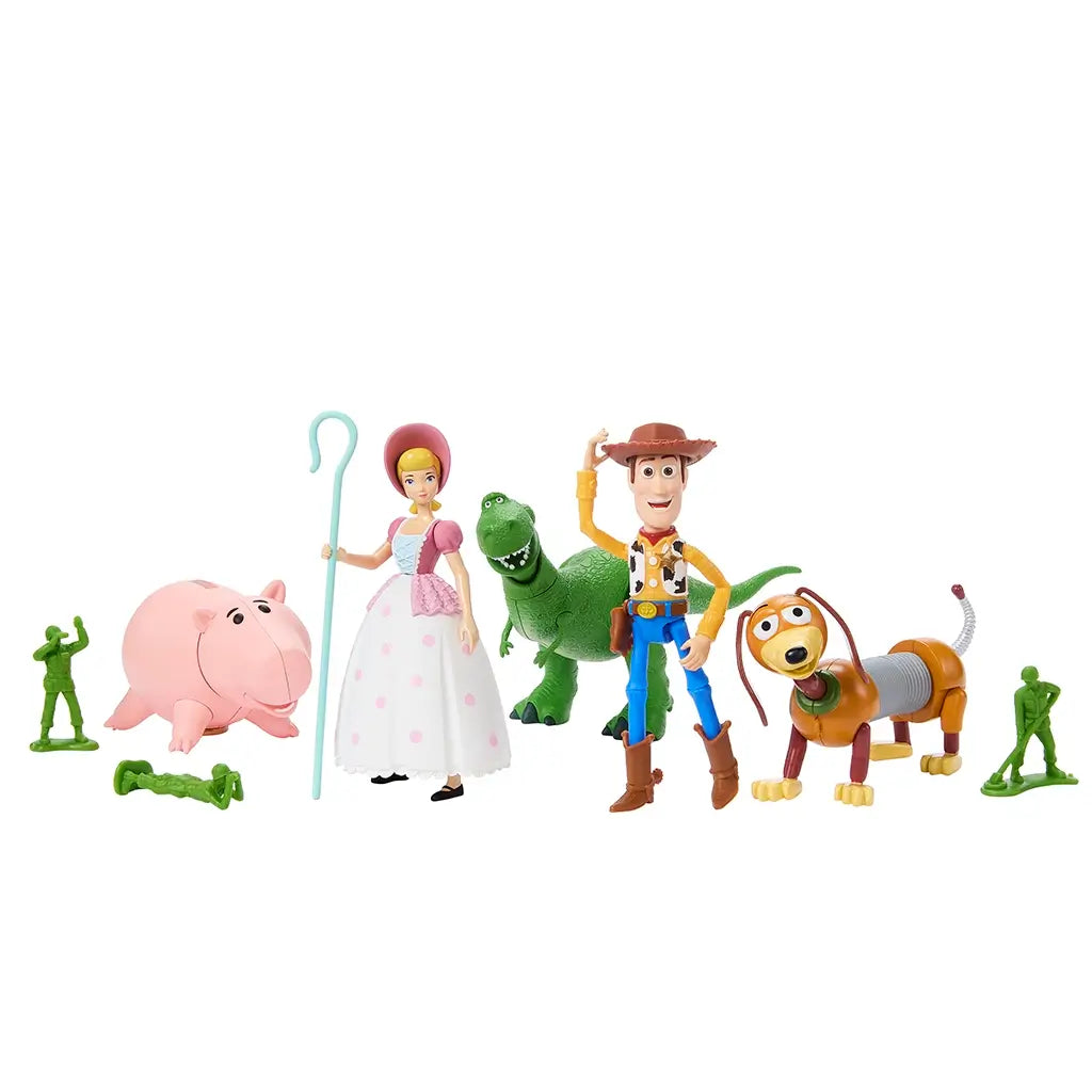 Colorful Toy Story Storytellers figure set featuring Woody, Bo Peep, Rex, Hamm, Slinky Dog, and green army men posed upright in playful formation on a clean white surface.