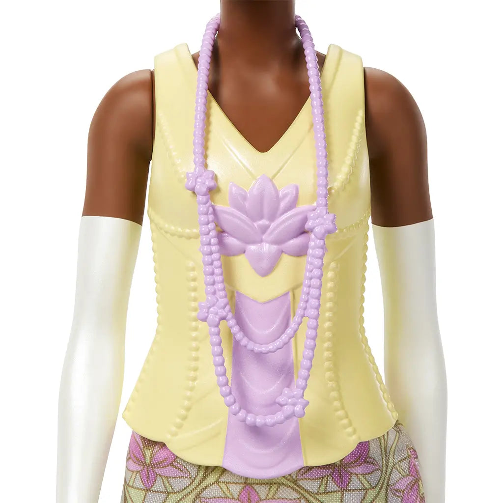 Close-up of Disney Princess Tiana doll outfit featuring detailed yellow bodice with lavender lotus design and layered lavender beaded necklace, paired with floral skirt.