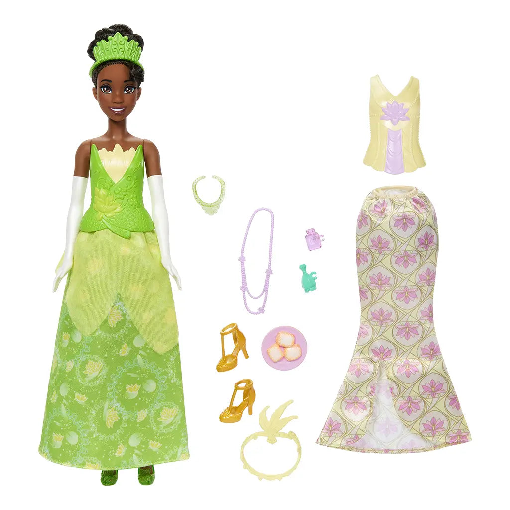 Disney Princess Tiana doll in sparkling green ballgown with floral patterns, matching tiara, gloves, necklace, and shoes, holding frog accessory for fairytale adventures.