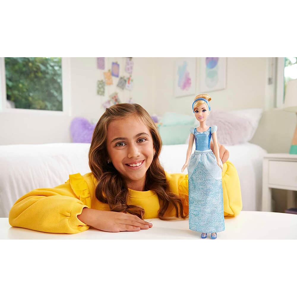 Girl playing with the Disney Princess Cinderella Fashion Doll