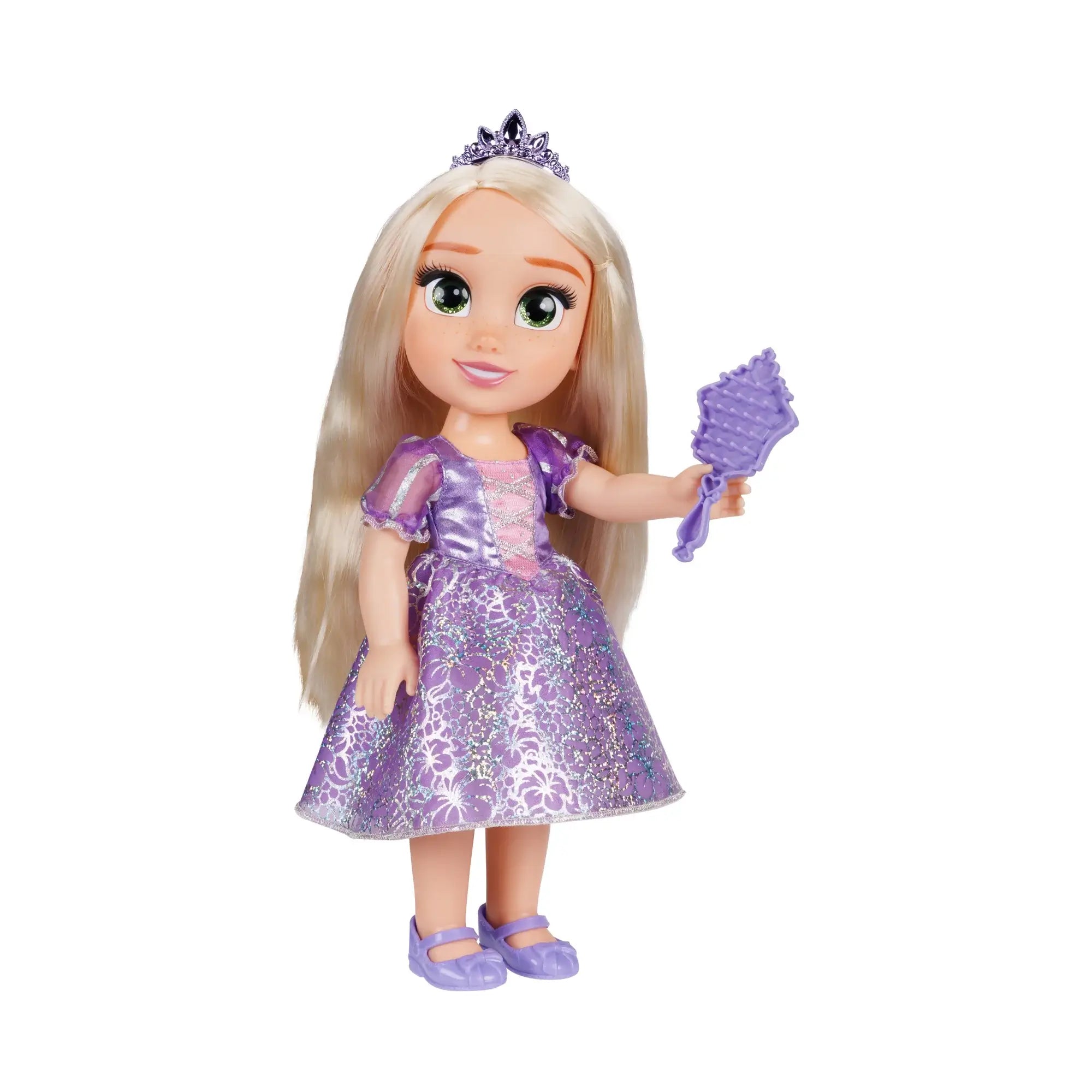 Disney Princess Rapunzel doll in a purple satin-look floral gown, jeweled tiara, and lavender shoes, holding a purple hairbrush beside long blonde hair on white background.