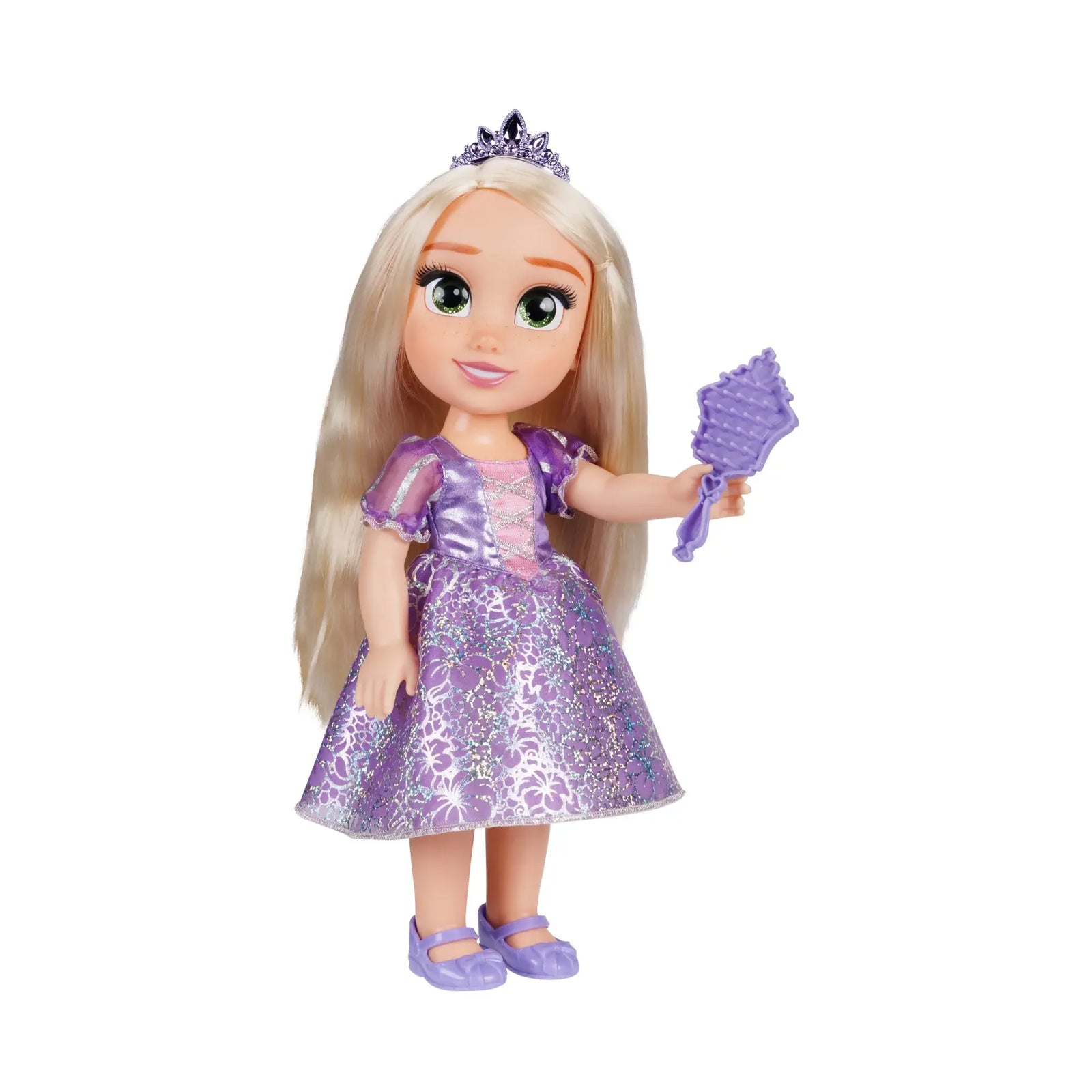 Disney Princess Rapunzel doll in a purple satin-look floral gown, jeweled tiara, and lavender shoes, holding a purple hairbrush beside long blonde hair on white background.
