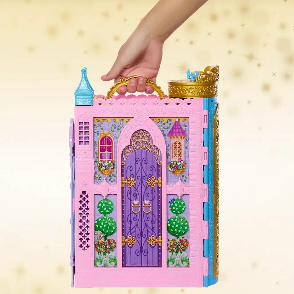 Toy Disney Princess castle with decorative elements - hand holding handle on carry-on-go style fold-up set.